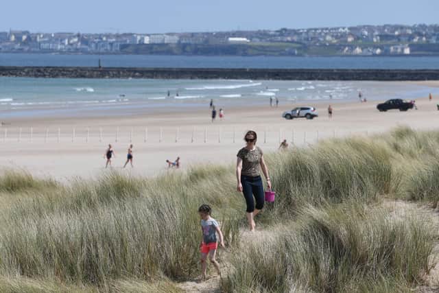 People enjoy the sunshine on Castlerock beach at the end of May. The weather in Northern Ireland was oustanding in April and May, which meant some form of payback was due in terms of lots of dull summer days, writes Ben Lowry. Picture: Michael Cooper