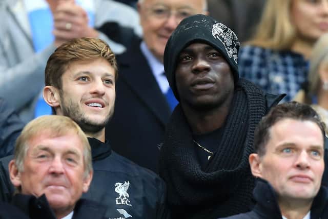 Liverpool's Adam Lallana (left) and Mario Balotelli in the stands during the Barclays Premier League match at the Etihad Stadium, Manchester on August 25, 2014. Pic by PA.