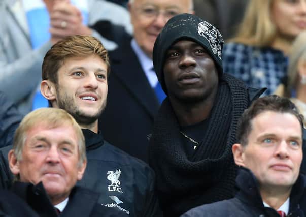 Liverpool's Adam Lallana (left) and Mario Balotelli in the stands during the Barclays Premier League match at the Etihad Stadium, Manchester on August 25, 2014. Pic by PA.