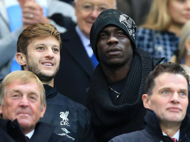 Liverpool's Adam Lallana (left) and Mario Balotelli in the stands during the Barclays Premier League match at the Etihad Stadium, Manchester on August 25, 2014. Pic by PA.