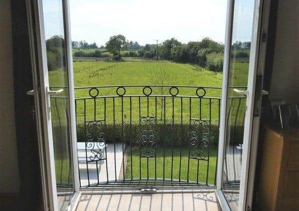 The master bedroom has a feature balconette with french doors