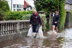 Local residents work to clear the water in Bryansford Avenue Newcastle.

Heavy downpours and flooding this morning have caused disruption across Northern Ireland. Pic PressEye