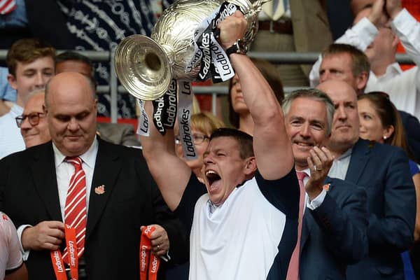 Hull FC coach Lee Radford lifts the trophy as they celebrate winning the Challenge Cup Final match at Wembley Stadium, London.