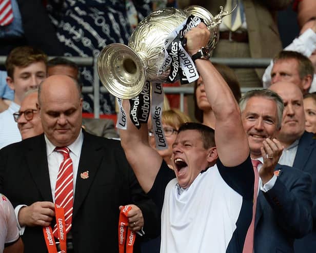 Hull FC coach Lee Radford lifts the trophy as they celebrate winning the Challenge Cup Final match at Wembley Stadium, London.