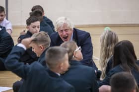 Prime Minister Boris Johnson in the gym taking part in a getting to know you induction session with year sevens as he tours Castle Rock school, Coalville, in the east Midlands. PA Photo. Picture date: Wednesday August 26, 2020. See PA story POLITICS Coronavirus. Photo credit should read: Jack Hill/The Times/PA Wire
