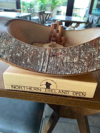 The tropy made from wood from the Dark Hedges