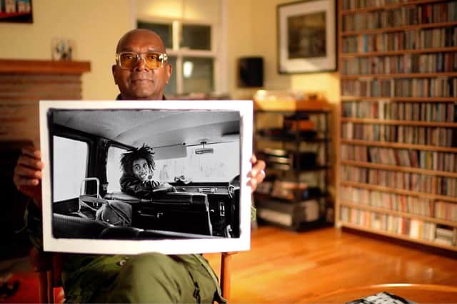 Dennis Morris, photographer, with the photo of Bob Marley he took on his tour bus in 1973