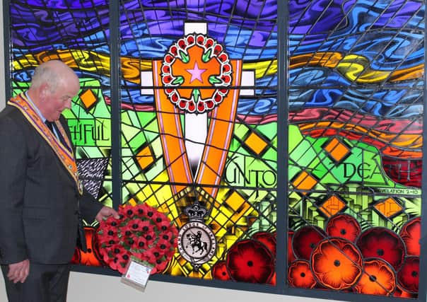 Caption: Grand Master Most Wor. Bro. Edward Stevenson pictured laying a wreath at the memorial window at Schomberg House in 2019.