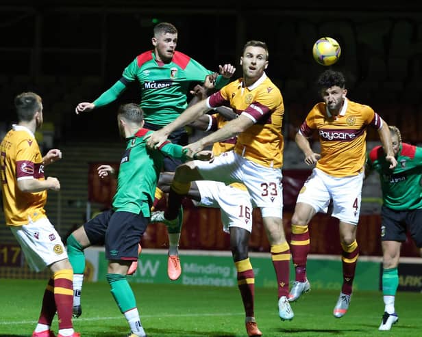 Glentoran's Rory Donnelly battles with Motherwell's Stephen O'Donnell. Pic by Pacemaker.