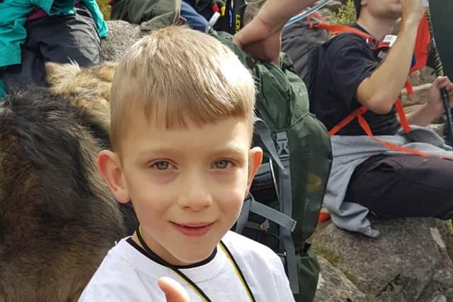 Handout photo issued by Lisa Thomson of Caeden Thomson, a seven-year-old with cerebral palsy, during his climb to the summit of Ben Nevis for charity on Saturday