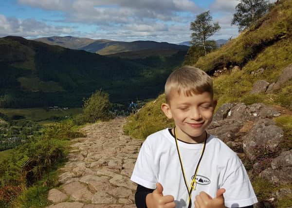 Handout photo issued by Lisa Thomson of Caeden Thomson, a seven-year-old with cerebral palsy, during his climb to the summit of Ben Nevis for charity on Saturday