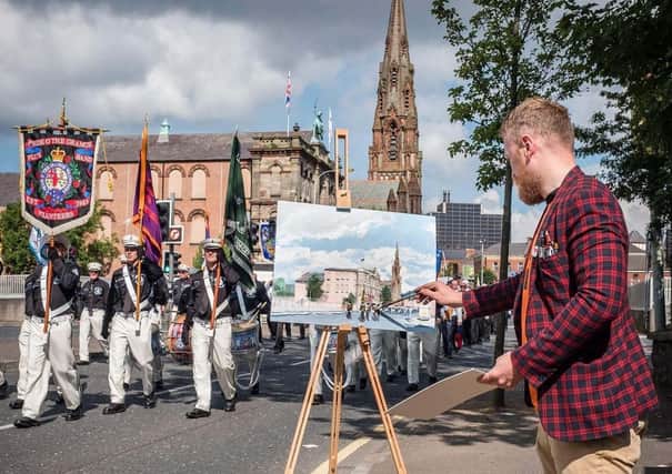 The artist Brian John Spencer paints a loyalist band on the Twelfth in Belfast in 2017. He regrets embracing the satirical group LAD (Loyalists Against Democracy)