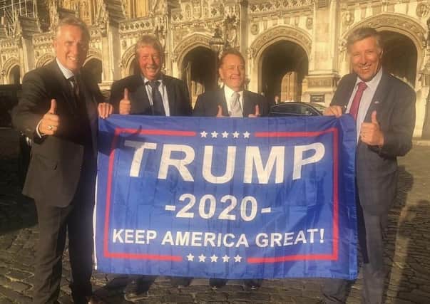 DUP MPs pose with a 'Keep America Great' banner in support of Donald Trump