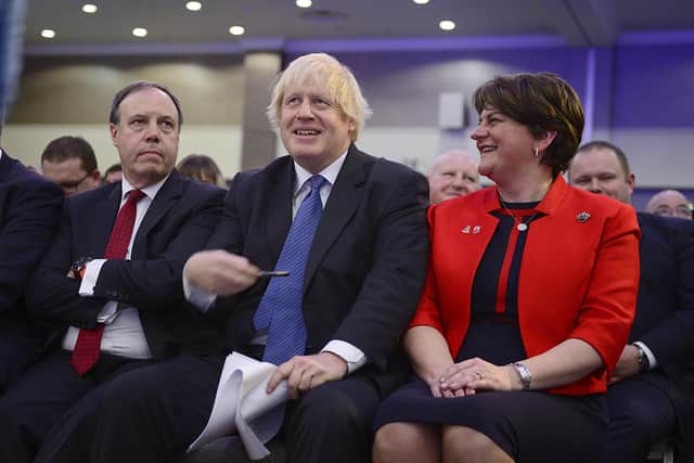 Boris Johnson with Nigel Dodds and Arlene Foster at the DUP conference in 2018. Johnson told bare-faced porkies to the gathering, writes Alex Kane