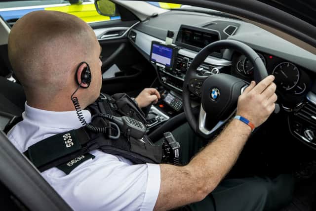 A PSNI officer sits in the driving seat of a BMW  police vehicle on show during the launch by the PSNI of the new Automatic Number Plate Recognition (ANPR) Intercept Team in Lisburn.