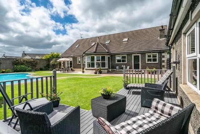 Exterior features include a raised decked area for outside entertaining