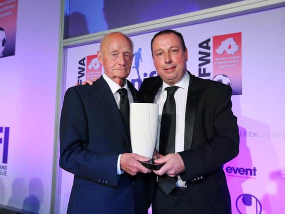 Andy Kerr pictured receiving the NIFWA Merit Award from Linfield chairman Roy McGivern in 2017