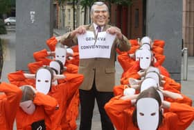 An Amnesty International protest in Belfast in 2008, which accused George Bush of ripping up international law over the use of Guantanamo Bay naval facility to house suspected jihadists and enemy combatants
