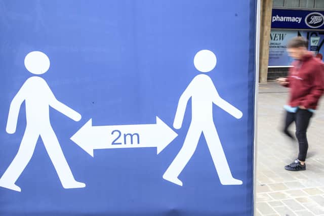 A social distancing sign in Leeds city centre, West Yorkshire, where tougher lockdown measures may be introduced locally after a rise in coronavirus infections