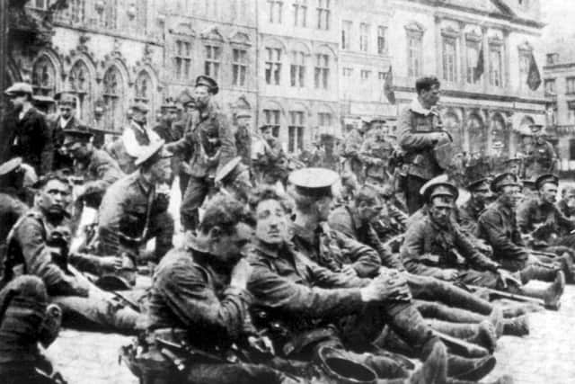 British soldiers resting in town square prior to the Battle of Mons, Belgium.  August 23, 1914