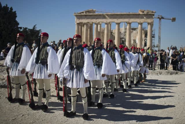 Members of the Presidential Guard stand on the Acropolis of Athens, with the 5th century BC Parthenon temple in the background on Thursday, October 12, 2017, during a ceremony on the 73rd anniversary of the liberation of Athens from Nazi German occupation during the Second World War. Picture: AP Photo/Petros Giannakouris