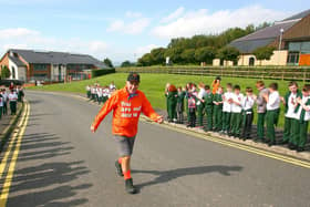 Fleming Keery after just completing a 3000 mile walk receives a guard of honour from children from St. Joseph's Primary School, Carryduff.Photo: Peter O' Hara Photography