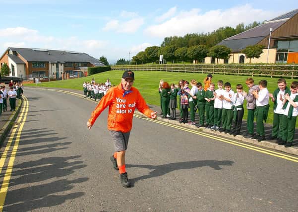 Fleming Keery after just completing a 3000 mile walk receives a guard of honour from children from St. Joseph's Primary School, Carryduff.
Photo: Peter O' Hara Photography