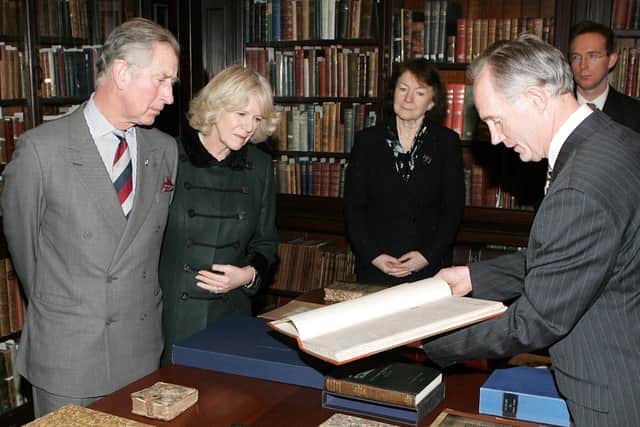 Prince Charles and Camilla are shown the earliest surviving edition of the News Letter, from 1738, a year after the paper's launch, at Belfast’s Linen Hall library on a 2009 visit. Picture Brian Little