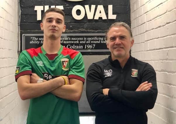 Jay Donnelly and Glentoran manager Mick McDermott at the Oval after he signed for the club on Wednesday