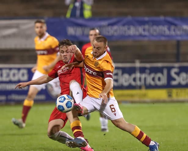 Ben Doherty battles with 
Motherwell's Allan Campbell in Europa League defeat last night for Coleraine. Pic by Pacemaker.