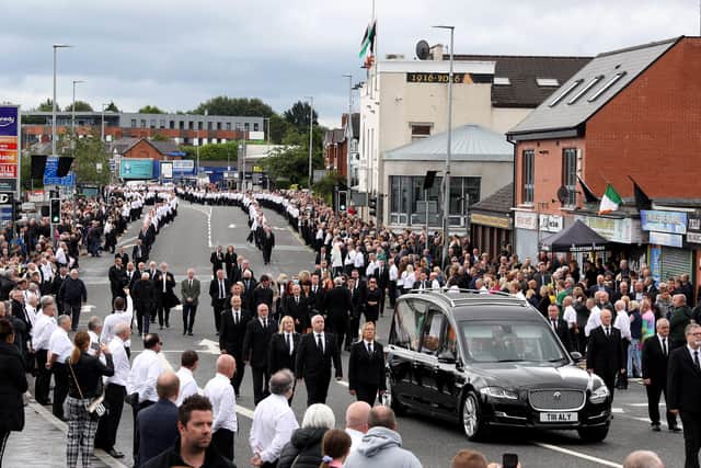 The funeral procession of  IRA man Bobby Storey was watched by thousands in west Belfast