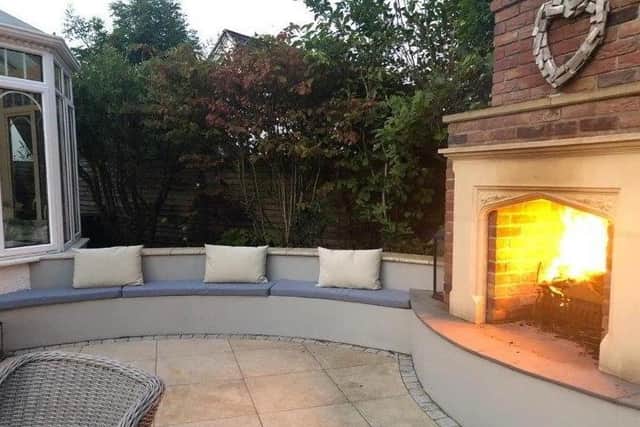 Outside, the property has a patio with seating and a fireplace.