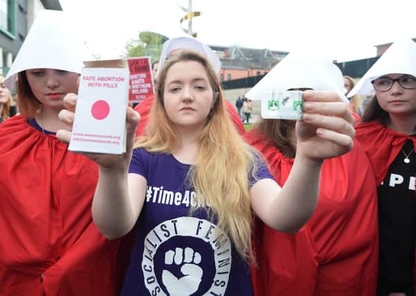An abortion activist with pills in Belfast in 2018