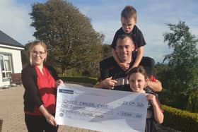 Accepting a cheque on behalf of Charis handed over by Angela McCabe's husband Frank and children Emma and Michael.