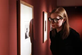 Anna Liesching, Curator of Art, National Museums NI viewing one of artworks at the Ulster Museum