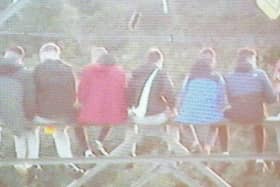 A resident took this picture of teenagers sitting high up on an electricity pylon