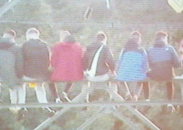 A resident took this picture of teenagers sitting high up on an electricity pylon