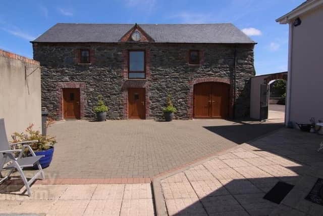 The property also comes with coach houses to the rear