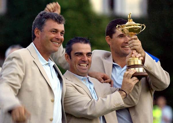 Europe's (left-right) Darren Clarke, Paul McGinley and Padraig Harrington celebrate with the Ryder Cup after defeating USA at the Belfry, near Sutton Coldfield in 2002.