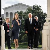 Judge Amy Coney Barrett, President Donald Trump's conservative nominee to the Supreme Court and Vice President Mike Pence arrive at the Capitol in Washington DC where she met with senators on Tuesday. The Supreme Court is seen behind (Erin Schaff/The New York Times via AP, Pool)