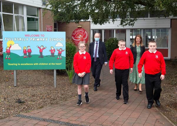 At Tullygally Primary School in Craigavon, Peter Weir met with pupils, Conor and Matthew Hobson, Molly Forker and principal, Kirsty Andrews. Picture: Michael Cooper