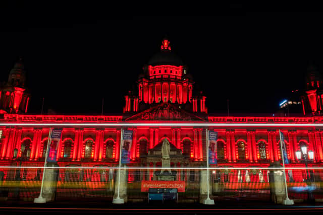 Belfast City Hall is lit red to support the under threat music industry
