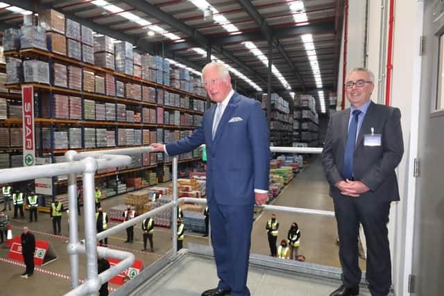 Martin Agnew (right) gives the Prince of Wales a tour of the Henderson Group's food and grocery distribution centre in Newtownabbey.  PA Photo. Picture date: Wednesday September 30, 2020. See PA story ROYAL Ulster. Photo: Niall Carson/PA Wire