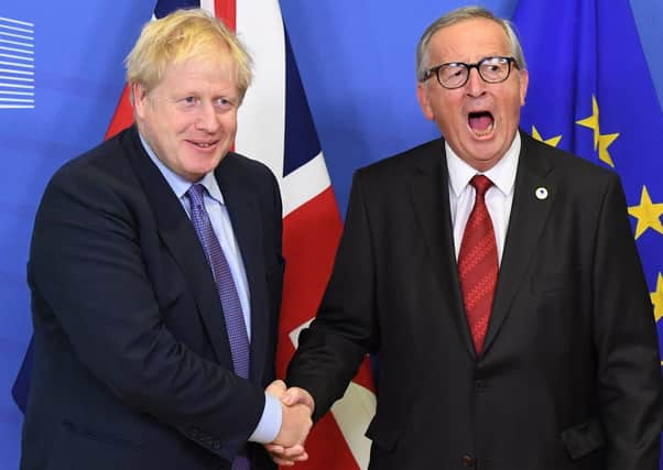 UK Prime Minister Boris Johnson and then Jean-Claude Juncker, President of the European Commission, shake hands after coming to an agreement on the withdrawal agreement Prime Minister Johnson helped to design. (Photo: PA Wire)