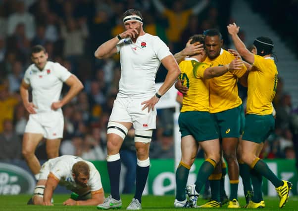 Chris Robshaw and Tom Wood (C) of England react as Bernard Foley of Australia celebrates scoring their first try with team mates during the 2015 Rugby World Cup Pool A match between England and Australia at Twickenham Stadium.  (Photo by Mike Hewitt/Getty Images).