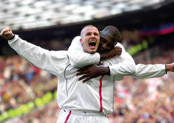 England's captain David Beckham (front) celebrates with team-mate Emile Heskey after scoring the equaliser from a free kick against Greece in the dying seconds of European Qualifying match at Old Trafford, Manchester in 2001.