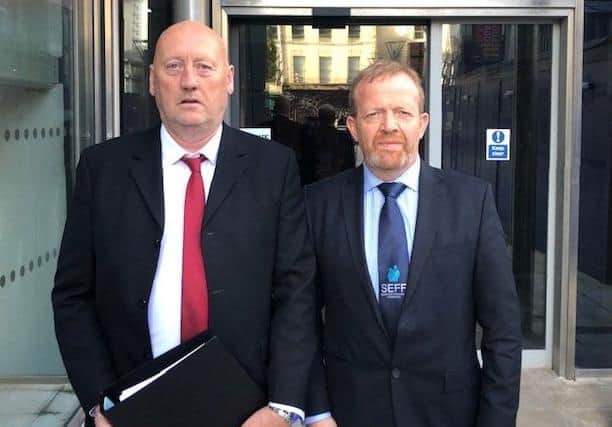 John Sproule and Ken Funston delivering a file to the Attorney General last year, calling for a new inquest into the murder of John's brother, Ian.
