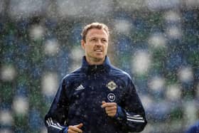 Northern Ireland's Jonny Evans in a rain shower during Saturday's training session at the International Stadium at Windsor Park, ahead of the Euro Nations League game against Austria. Photo: William Cherry/Presseye.
