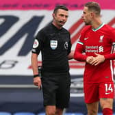 Liverpool's Jordan Henderson (right) appeals to Match referee Michael Oliver
