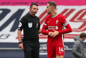Liverpool's Jordan Henderson (right) appeals to Match referee Michael Oliver